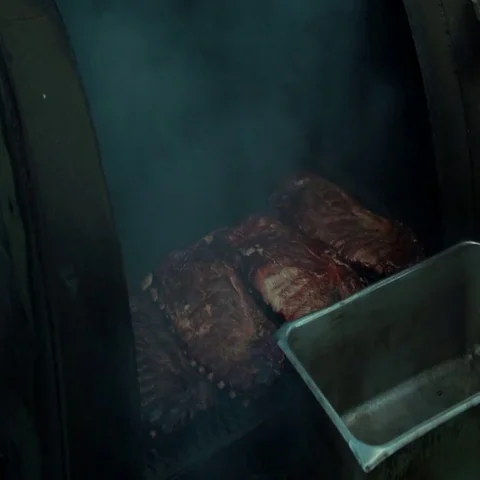 Ribs smoke on a barbeque pit. Stock Footage 69513766