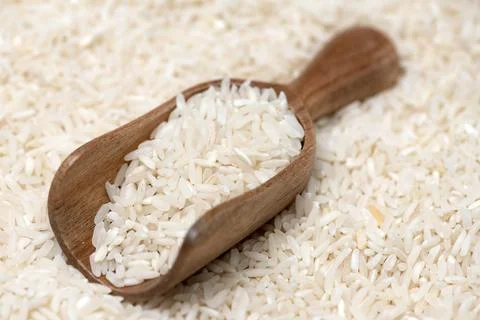 Rice background with pattern. Rice in scoop. Rice close up with grains. Ric.. Stock Photos