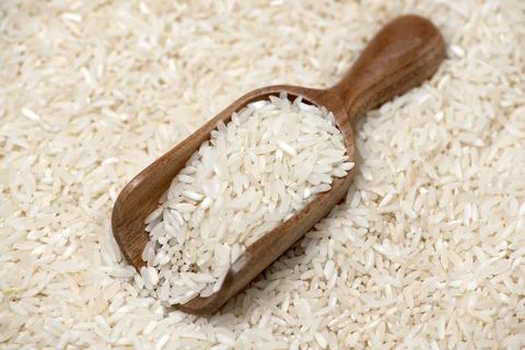 Rice background with texture. Rice in rustic scoop. Rice close up with grai.. Stock Photos