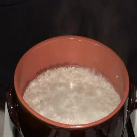 Rice boiling in a clay pot Stock Footage 69320581
