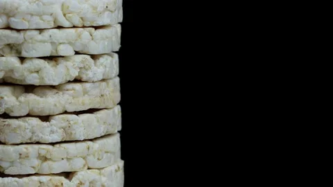 Rice bread with buckwheat. Rice cake rotating on a black background Stock Footage 144268327