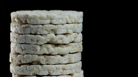 Rice bread with buckwheat. Rice cake rotating on a black background Stock Footage 144268441