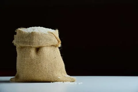 Rice in burlap sack Stock Photos
