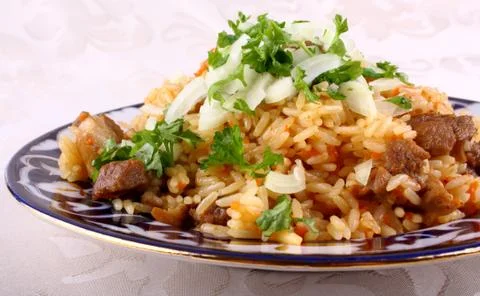 Rice cooked with meat, oriental risotto Stock Photos