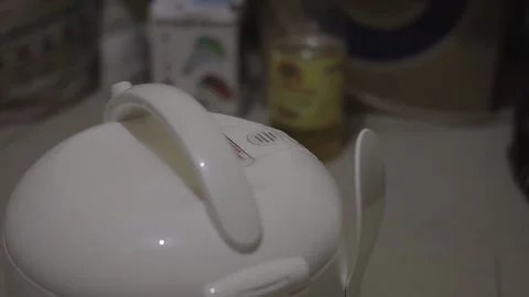 Rice cooker emitting steam while cooking rice Stock Footage 204851992