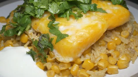 Rice with corn, smoked basa fillet and coriander sprinkled on top. Stock Footage 114982626