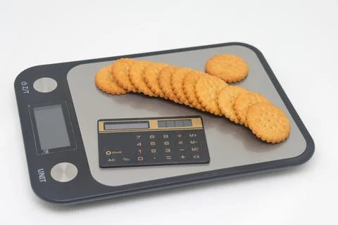 Rice crackers on digital kitchen scale promoting healthy eating lifestyle. Stock Photos