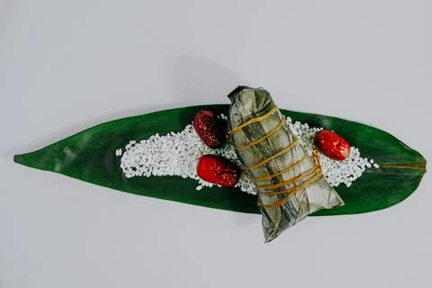 Rice dumpling on green leaf with dates Stock Photos