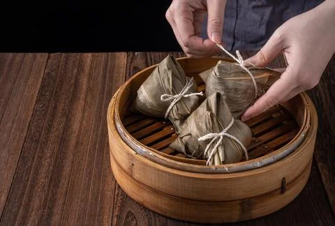 Rice dumpling, zongzi - Bunch of Chinese traditional cooked food on wooden ta Stock Photos