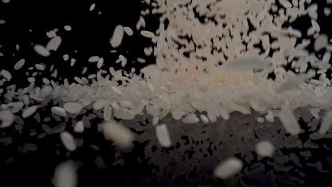 Rice falling on black surface against black background. Slow Motion. Video stock 128770182