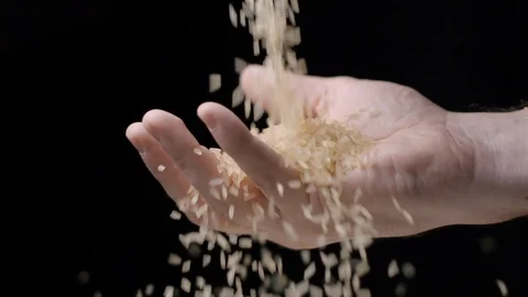 Rice falling in hand slow motion Stock Footage 99092399