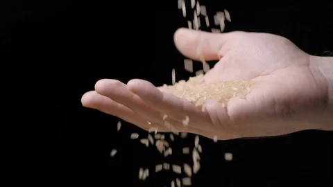 Rice falling in hand slow motion Stock Footage 99092586