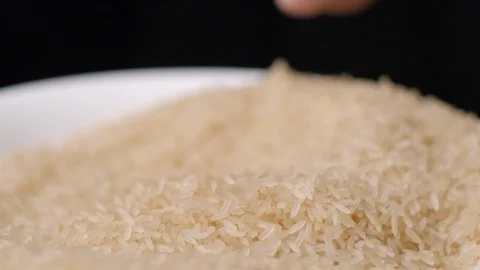 Rice falling in hand slow motion Stock Footage 99092932