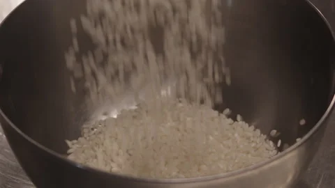 Rice falling in slow motion in a container Stock Footage 172073599