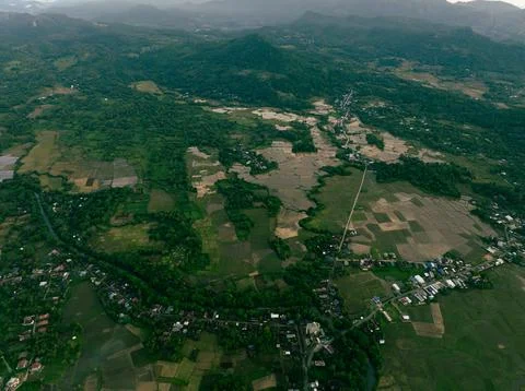 Rice Fields and Hamlet at Mountain Foot - Sunset Drone Shot 写真素材