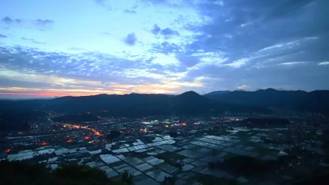 Rice fields and the morning glow seen from the summit Stock Footage 342229951
