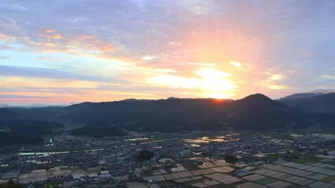 Rice fields and the morning glow seen from the summit Stock Footage 342229966