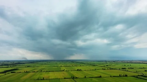 Rice fields under dramatic storm clouds in May rainy season Stock Footage 337526909