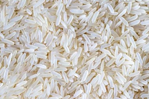 Rice grains background or texture. Healthy vegeterian food. Stock Photos