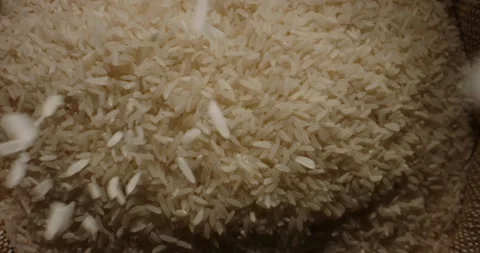 Rice grains fall into an open sack. Top view slow motion camera zoom. Concept Stock-Footage 243362337
