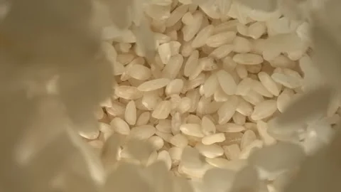 Rice grains falling in slow motion rustic texture top view Stock Footage 344848262