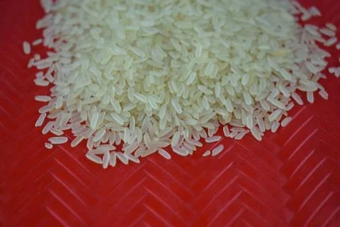 Rice grains held in a designed red carpet where the rice grains are stacked Stock Photos