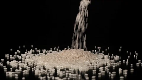 Rice grits fall on the table on  black background. Stock Footage 125640814