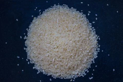 Rice groats on a dark background. Stock Photos