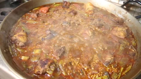 Rice with meat and vegetables. Authentic Valencian paella made with firewood Stock Footage 153274133