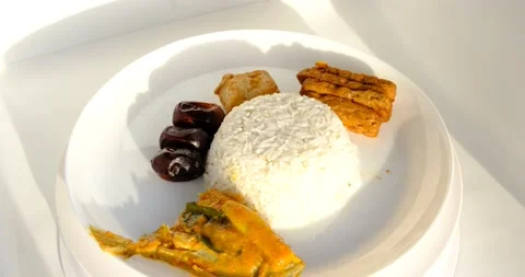Rice with a menu of tempeh, dates and Rambe Fish Stock Footage 230119539