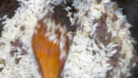 Rice is mixed with meat in the pan Video stock 221427899