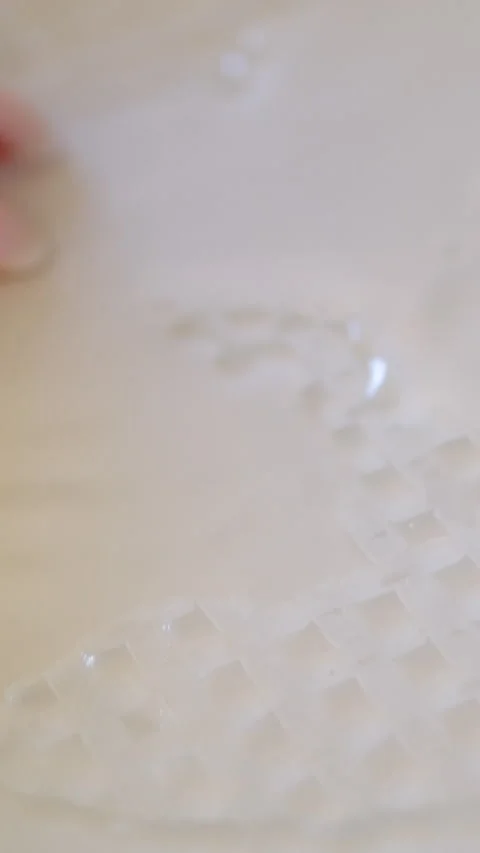 Rice paper dip in water Side view of a sushi chef hands leveling triangle Stock Footage 302730356