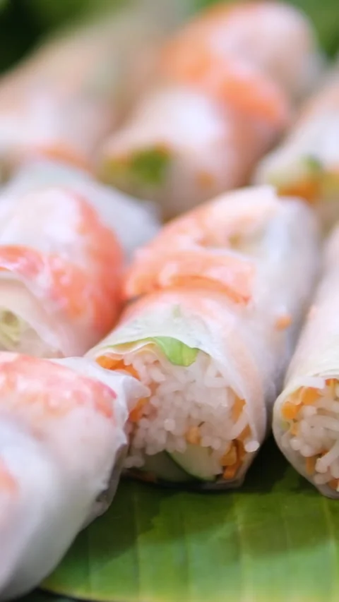 Rice paper rolls Tourists prepare and eat spring roll with rice paper wrapper or Stock Footage 311925359