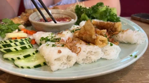 Rice paper rolls Tourists prepare and eat spring roll with rice paper wrapper or Stock Footage 323924562