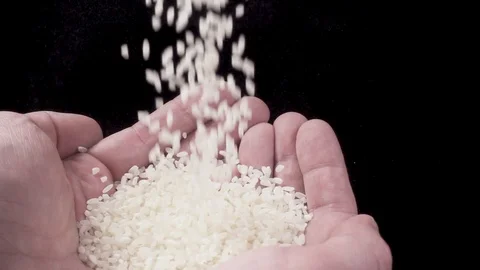 Rice is poured into the man's palms Video stock 87290025
