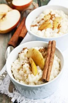 Rice Pudding with Apple Slices and Cinnamon Spice Sticks Stock Photos