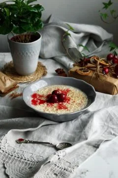 Rice pudding with cinnamon and cherries Stock Photos