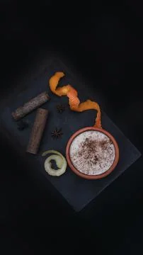 Rice pudding dessert served in an earthenware dish on a slate table accompani Stock Photos