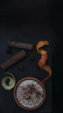 Rice pudding dessert served in an earthenware dish on a slate table accompani Stock Photos