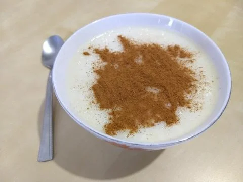 Rice pudding with ground cinnamon Stock Photos