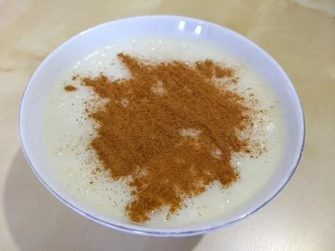 Rice pudding with ground cinnamon Stock Photos
