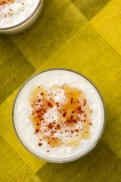 Rice pudding with maple sirup overhead view. Stock Photos