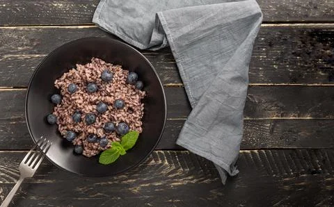 Rice pudding with maple syrup and blueberries Stock Photos