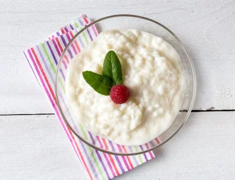 Rice pudding with mint and raspberry Stock Photos