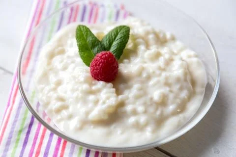 Rice pudding with mint and raspberry Stock Photos