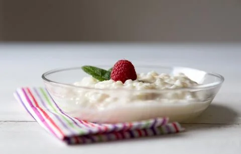 Rice pudding with mint and raspberry Stock Photos