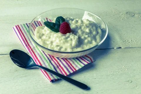 Rice pudding with mint and raspberry Stock Photos