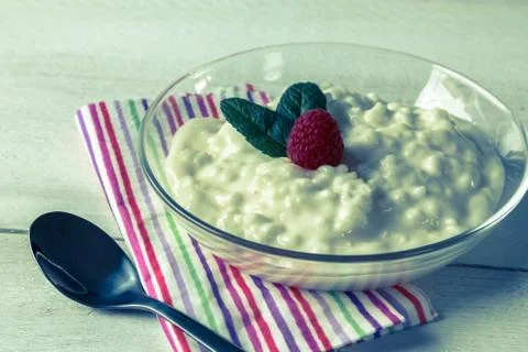 Rice pudding with mint and raspberry Stock Photos