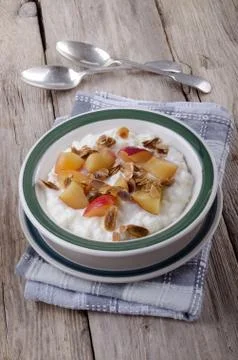 Rice pudding with nectarines and roasted almond sliver Stock Photos