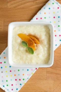 Rice pudding in a square white plate. Dessert serving, top Stock Photos